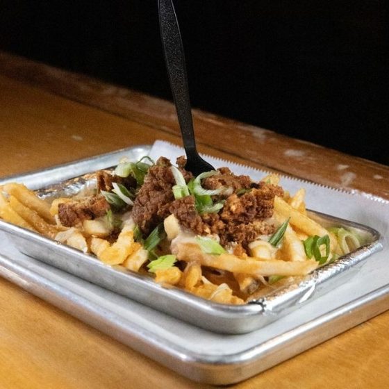 plate of poutine with fries and toppings